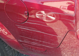 scratches and scrapes down side of car